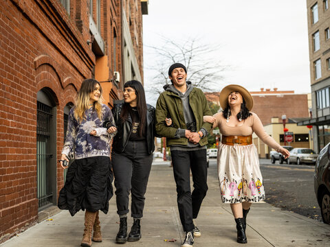 Young Indigenous friends walking outdoors