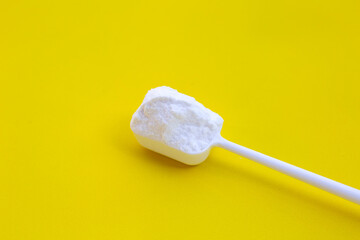 Baking soda on yellow background.