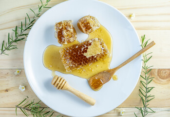 Yellow Honeycomb in white plate on wooden background, Sweet Honeycomb on wooden background, 