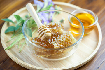 Honeycomb in wooden plate on wooden background, Yellow Honeycomb on wooden table.