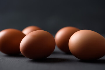 Fresh organic chicken eggs on black background