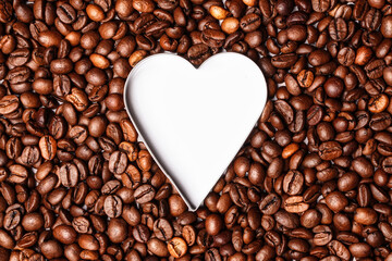 White heart inside roasted coffee beans. Coffee lovers wallpaper