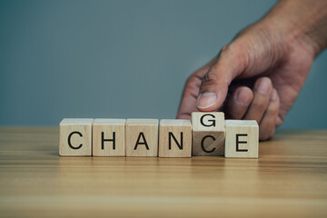 Closeup hand flips one cubes with trending the word chance to change.