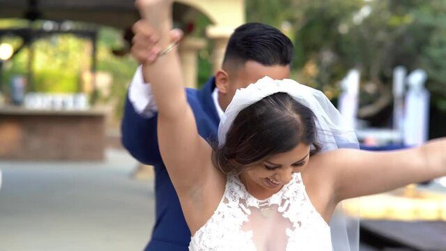 Mexican wedding couple walking and having fun and dancing