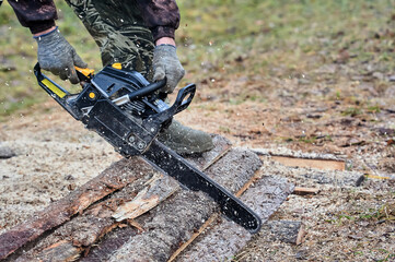 a chainsaw is used to cut wood outdoors