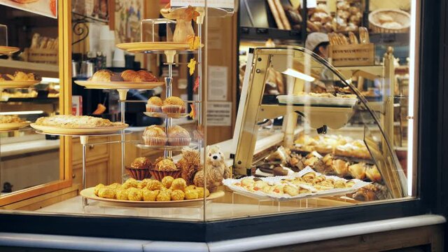 Delicious sweets pastries in patisserie cafe. Showcase of bakery close-up.