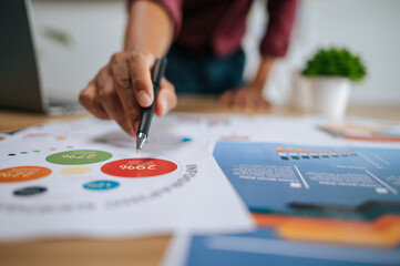 Male employee presenting work with documents