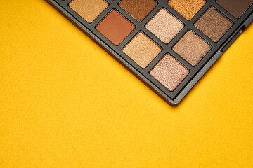 cosmetics mascara brushes decoration accessories yellow background