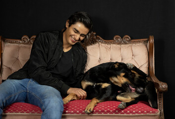 Obraz premium boy laughing in amusement because his dog is licking his privates