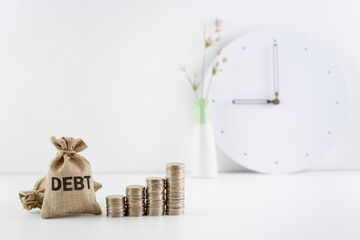 Debt financing, unsecured consumer debt, financial concept : Debt bags and coins on a table, represent the increasing total interest expense a borrower must repay to a lender when making late payment.