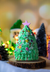 Butter cream cake decorate for Christmas festival with green butter cream and sweet candy, closeup.