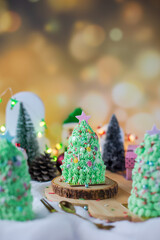 Butter cream cake decorate for Christmas festival with green butter cream and sweet candy, closeup.