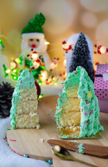Butter cream cake decorate for Christmas festival with green butter cream and sweet candy, closeup.
