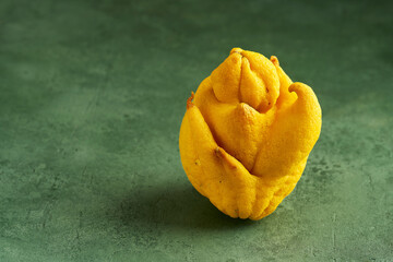 Ugly lemon oh green background. Ugly food and  vegetables concept . Close up