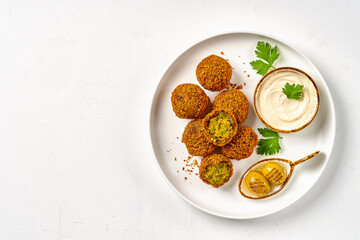 Chickpeas falafel with tahini sauce. Top view, copy space