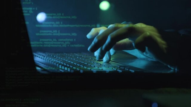 Cyber Crime Concept - Hacker Working And Typing Security Codes On Laptop. - close up