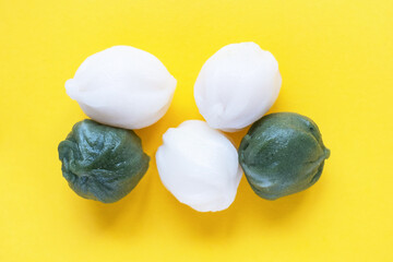 Korean traditional sweet rice snack tteok isolate on yellow background.