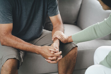 Female friend or family sitting and hold hands during cheer up to mental depress man, Psychologist...