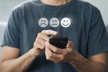 Close up of man customer touching smartphone screen on the happy Smile face icon to give satisfaction. Review, Service rating, satisfaction, Customer service experience concept. - obrazy, fototapety, plakaty