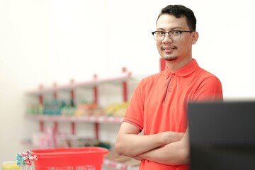 Asian young man chasier wear uniform smiling at the camera