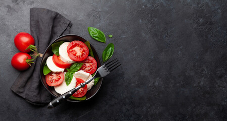 Caprese salad with fresh tomatoes, basil and mozzarella cheese