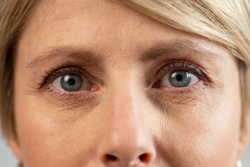 A 50-year-old middle-aged woman looks into the camera, anti-aging skin care, beauty, plastic...