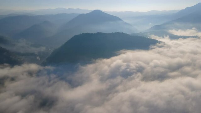 Aerial view Motion Time-lapse over the sea of fog among the valley during the morning sunrise, Unseen travel in Mae Hong Son Northern Thailand