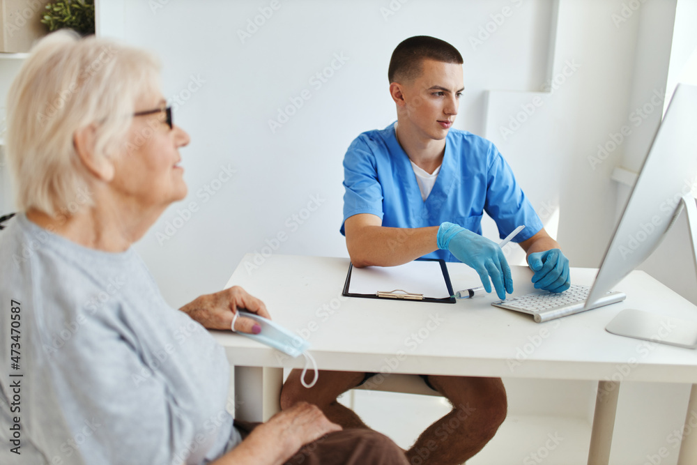 Wall mural elderly woman at the doctor's appointment health care