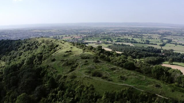 AERIAL - Beautiful hills, Uley, Cotswolds, England, forward spinning shot tilt down