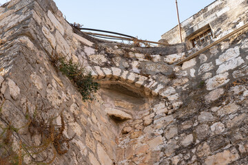 The remains  of the stone arched connection on quiet small St James Street in the Armenian quarter in the old city of Jerusalem, Israel