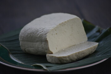 Tofu, also known as bean curd or Tahu in Indonesia language, is a food prepared by coagulating soy milk fermentation and then pressing the resulting curds into solid white blocks of varying softness 