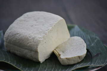 Tofu, also known as bean curd or Tahu in Indonesia language, is a food prepared by coagulating soy milk fermentation and then pressing the resulting curds into solid white blocks of varying softness 