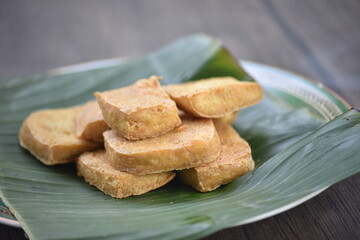 Tofu, also known as bean curd or Tahu in Indonesia language, is a food prepared by coagulating soy milk fermentation and then pressing the resulting curds into solid white blocks of varying softness 