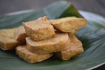 Tofu, also known as bean curd or Tahu in Indonesia language, is a food prepared by coagulating soy milk fermentation and then pressing the resulting curds into solid white blocks of varying softness 