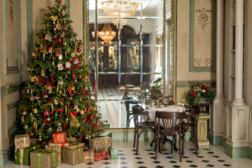 Fototapeta na wymiar Christmas morning interior with christmas tree Vintage chandelier. White, red and gold balls on the Christmas tree.
