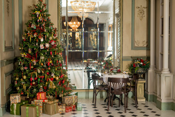 Christmas morning interior with christmas tree Vintage chandelier. White, red and gold balls on the Christmas tree.