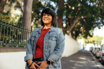 Happy mid-adult woman smiling at the camera outdoors