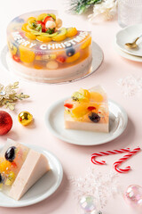 Homemade Fruit Pudding with strawberry, grape, orange, longan, kiwi and peach ingredients decorated with Christmas decorations