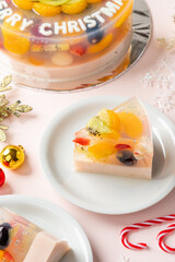 Homemade Fruit Pudding with strawberry, grape, orange, longan, kiwi and peach ingredients decorated with Christmas decorations