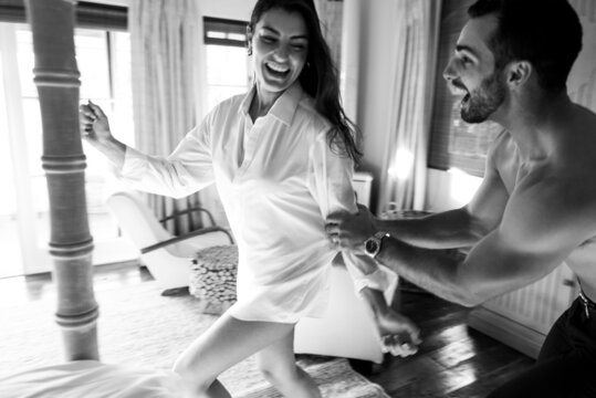 Man catching his wife during a game in their hotel room