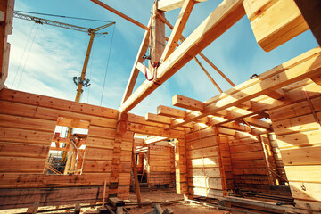 Timber building house construction log with blue sky sun light