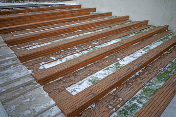 The benches for the audience in the open theater are empty on a cold winter day