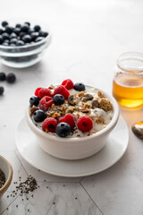 Bowl of muesli, granolla or oats with fresh berries, breakfast food.