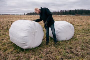 Farmer and haystacks packed for winter