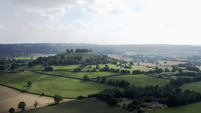 AERIAL -  Epic fantasy shot of green hills near Uley, Cotswolds, England, circle pan