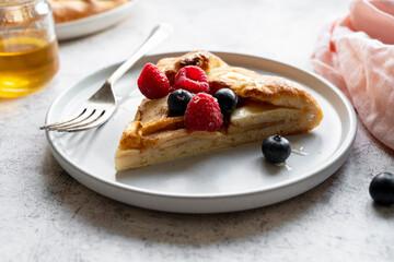 Apple tart or galette with cinnamon and fresh berries. Home baking.