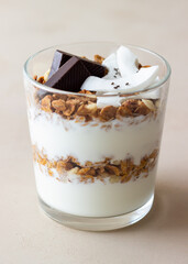 Granola with yogurt, coconut and chocolate. Muesli. Breakfast. Vegetarian food. Healthy eating.