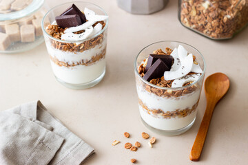 Granola with yogurt, coconut and chocolate. Muesli. Breakfast. Vegetarian food. Healthy eating.