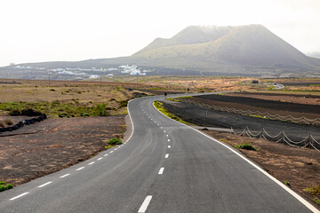 Long empty asphalt road on lanzarote, Canary Islands, Spain