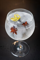 Gin tonic glass on the dark bar counter - mixology concept - three quarter view